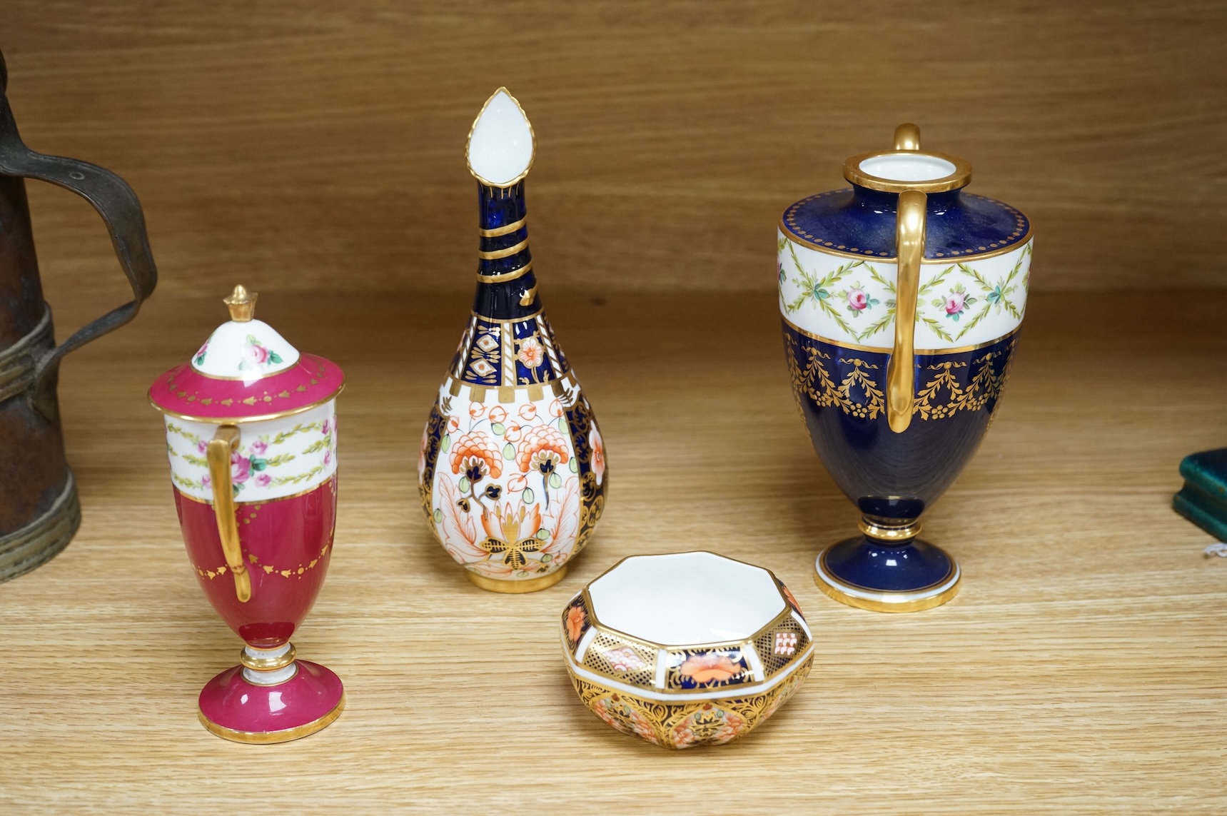 A Royal Crown Derby Imari miniature bowl and similar ewer, together with two Minton two handled vases, one with a cover, 18cm